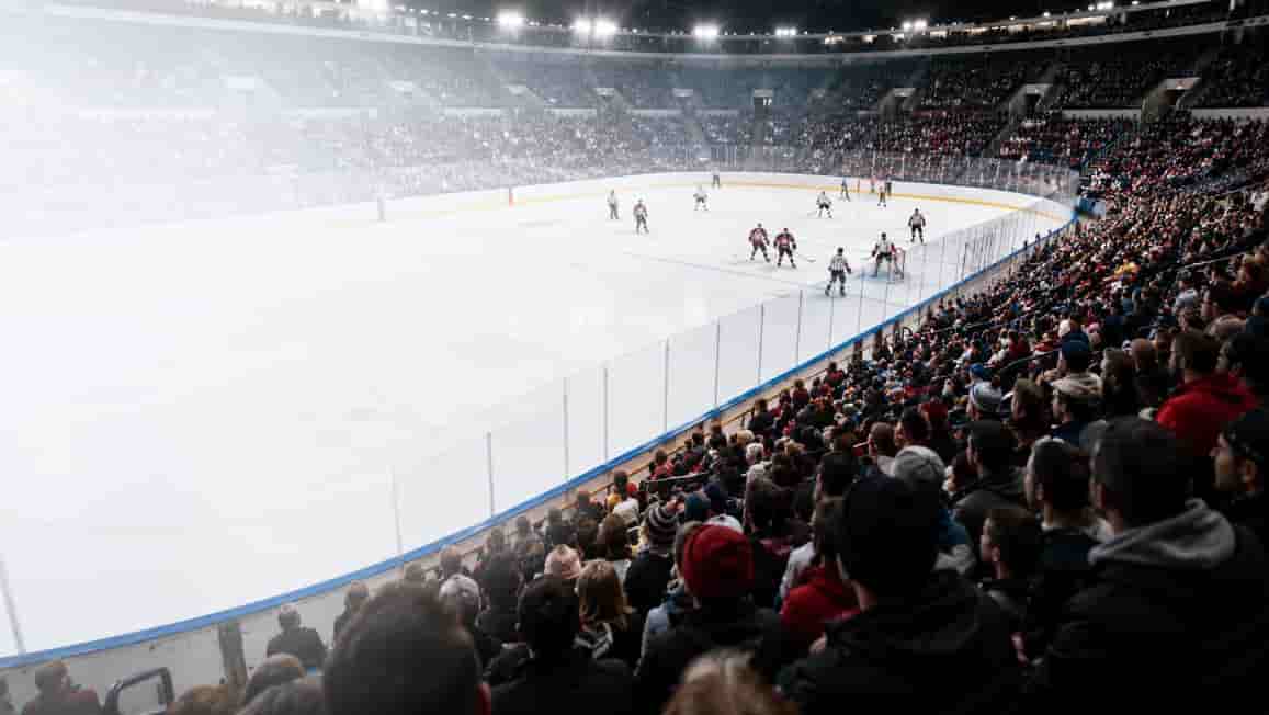 Wide view of an indoor hockey game in a crowded arena, used as the cover image for a Canadian sports betting beginner guide.